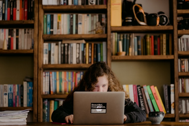 child sitting at a laptop